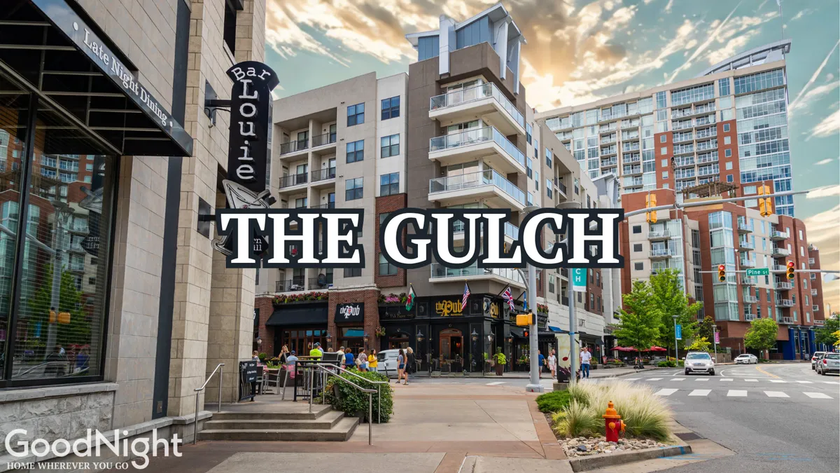 A lively exterior street scene in The Gulch, featuring the well-known neighborhood sign, Bar Louie, and bustling pedestrians among modern buildings. The atmosphere is energetic and contemporary, suggesting a hub of dining, shopping, and social activity.